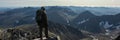 The concept of outdoor activities in the mountains. Man traveler on a background of mountains. Atmospheric view of the snowy slope