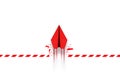 Concept of overcoming barriers, goals, and targets with a red paper plane breaking through an obstacle