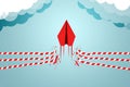 Concept of overcoming barriers, goals, and targets with a red paper plane breaking through an obstacle