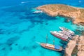 Concept paradise vacation. White yacht with sail in clear water of sea with sand. Blue Lagoon Comino Malta. Aerial view Royalty Free Stock Photo