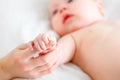 Concept of parental love. baby hand holding finger of mother Royalty Free Stock Photo