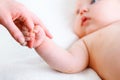 Concept of parental love. baby hand holding finger of mother Royalty Free Stock Photo