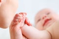 Concept of parental love. baby hand holding finger of mother Royalty Free Stock Photo