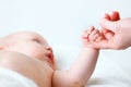 Concept of parental love. baby hand holding finger of mother Royalty Free Stock Photo