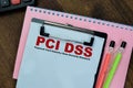 Concept of PCI DSS - Payment Card Industry Data Security Standard write on paperwork isolated on Wooden Table Royalty Free Stock Photo