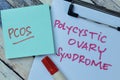 Concept of PCOS - Polycystic Ovary Syndrome write on sticky notes isolated on Wooden Table