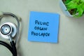 Concept of Pelvic Organ Prolapse write on sticky notes with stethoscope isolated on Wooden Table