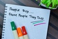 Concept of People Buy From People They Trust write on book isolated on Wooden Table Royalty Free Stock Photo