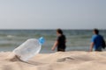 Abandoned PET plastic water bottle. The concept of littering the natural environment. Ecological damage on the beach