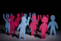 Concept of people strike and protest. Paper multi-colored little men with raised hands, on a dark background. Freedom and Royalty Free Stock Photo