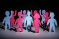 Concept of people strike and protest. Paper multi-colored little men with raised hands, on a dark background. Freedom and Royalty Free Stock Photo