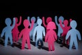 Concept of people strike and protest. Paper multi-colored little men with raised hands, on a dark background. Freedom and Royalty Free Stock Photo