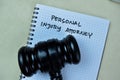 Concept of Personal Injury Attorney write on book with gavel isolated on Wooden Table Royalty Free Stock Photo