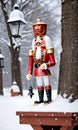 Photo Of Christmas Nutcracker Holding A Lantern Beside A Snow-Covered Birdhouse In A Snowy Par. Generative AI