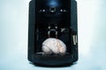 Coffee machine pouring into the brain concept