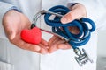 Concept photo diagnostics and treatment of diseases of heart and blood vessels. Doctor dressed in white lab coat in one hand holds