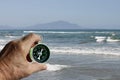 Concept photo on sandy beach with compass on shoes as symbol of tourism Royalty Free Stock Photo