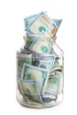 concept photo savings - a glass jar filled with 100 dollar bills