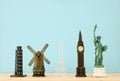 concept photo of some of the world famous landmark for travel , small statues over wooden table. Royalty Free Stock Photo