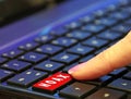 Finger pressing pushing down red hoax scam computer keyboard button word