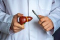 Concept photo of surgery on the liver and gallbladder hepatobiliary area. Surgeon holds a scalpel in one hand and a figurine of Royalty Free Stock Photo