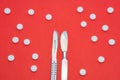 Concept photo of surgical and therapeutic treatment of various diseases. Two chrome-plated metal scalpel lying on red background n Royalty Free Stock Photo