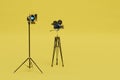 the concept of photo and video shooting. a camera on a tripod and a softbox on a yellow background. 3D render Royalty Free Stock Photo