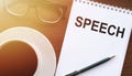 Concept photo of the word SPEECH. Text on notepad on office table Royalty Free Stock Photo