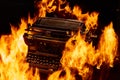 Concept shot of antique manual typewriter with paper burning on black background, selective focus Royalty Free Stock Photo