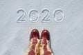 Concept picture.inscription New Year 2020 and footprints in the snow