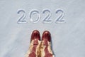 Concept picture.inscription New Year 2022 and footprints in snow