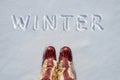 Concept picture.inscription Winter and national fur boots in the snow.