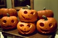 A Pile Of Carved Pumpkins Sitting On Top Of A Table. Generative AI Royalty Free Stock Photo