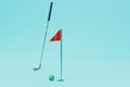 the concept of playing golf. a golf club next to a planet-shaped ball and a red flag on a blue background. 3D render Royalty Free Stock Photo