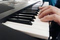 concept of playing musical instruments - the men's hands on the piano play a famous melody. Focus on the fingers and on the piano Royalty Free Stock Photo