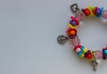 Concept For Postcard Of Wallpaper With Colorful Beads And Silver Charms Bracelet In A Side Of Image