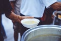 The concept of poverty and food shortages: homeless people wait to receive food donations from donors