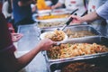 The concept of poverty leads to food shortages: homeless people wait to receive food donations from donors Royalty Free Stock Photo