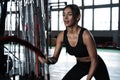 Powerful attractive muscular woman CrossFit trainer do battle workout with ropes at the gym Royalty Free Stock Photo