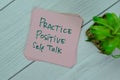 Concept of Practice Positive Self Talk write on sticky notes isolated on Wooden Table