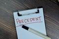 Concept of Precedent write on a paperwork isolated on Wooden Table Royalty Free Stock Photo