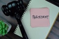 Concept of Precedent write on sticky notes with gavel isolated on Wooden Table