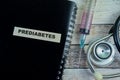 Concept of Prediabetes write on sticky notes with stethoscope isolated on Wooden Table Royalty Free Stock Photo