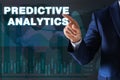 Concept of predictive analytics. Businessman pointing at phrase on virtual screen, closeup