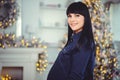 Concept of pregnancy, love, people and expectations - happy pregnant woman, stands in a room against the background of the Royalty Free Stock Photo