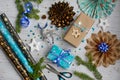 The concept of preparing gifts for the New Year and Christmas. Layout of gifts in blue packaging and decor on a light wooden Royalty Free Stock Photo