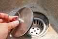 concept of preventing clogged pipes, Close-up shot of male hand holding bathtub stopper
