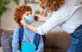 Concept of preventing a coronavirus covid-19 and viral infections. Mother puts on medical mask for little son before leaving home Royalty Free Stock Photo