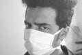 The concept of preventing the spread of the epidemic corona virus. man wearing face mask and looking at camera., black and white