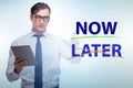 Concept of procrastination with now or later Royalty Free Stock Photo